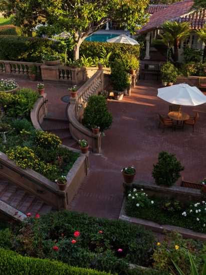 Landscaped grounds with brick paths and patios between planting