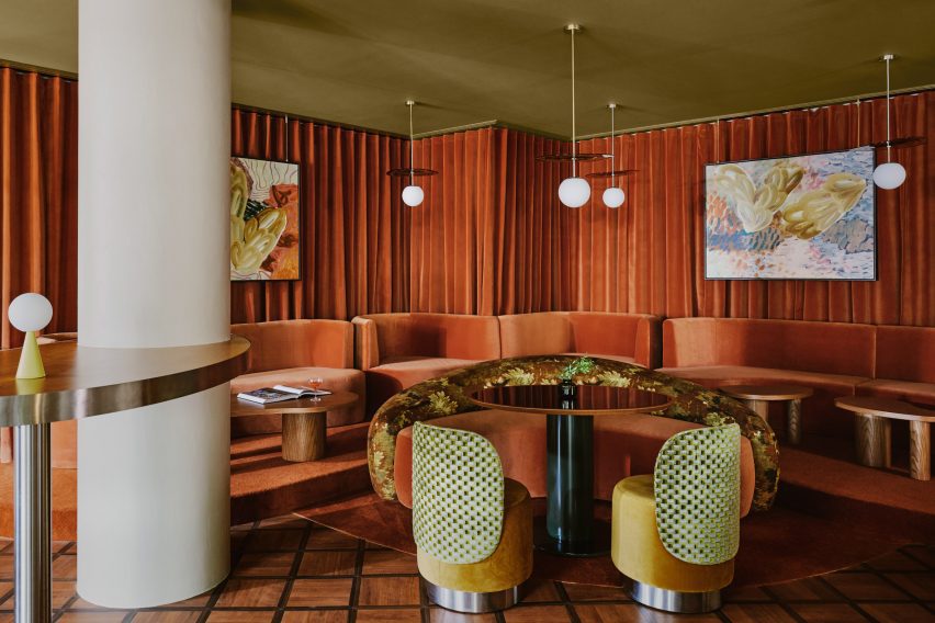 Seating area wrapped in terracotta curtains