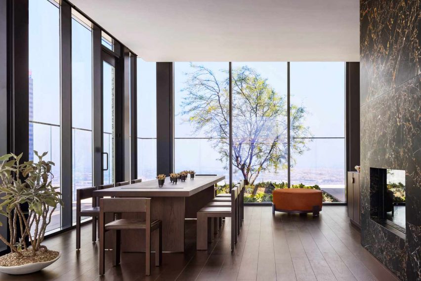 An interior room with large windows and shade