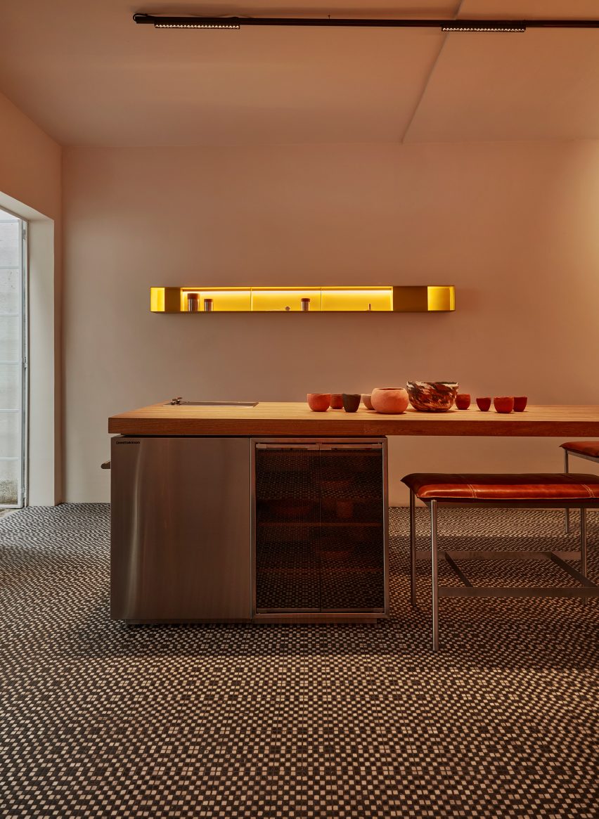A kitchen with tiled floors with yellow shelving
