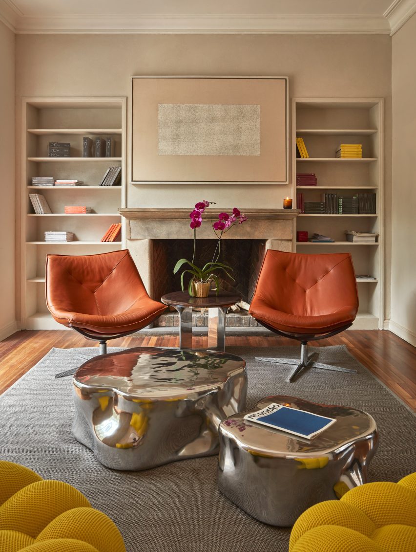 Two leather chairs in front of built in bookcase