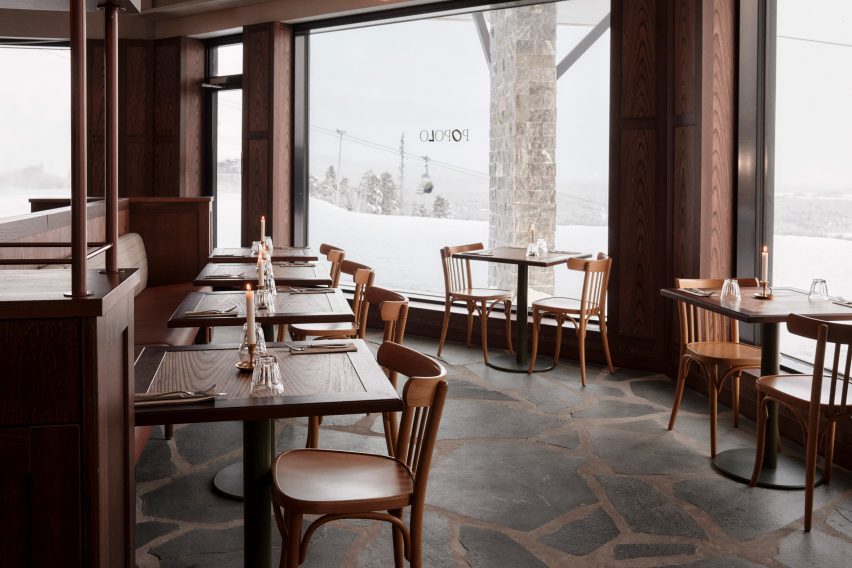 Dining tables and window overlooking ski slopes in Popolo pizza restaurant at Pyhä Ski Resort in Finland
