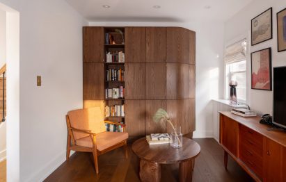 Living room featuring a dark oak storage unit with a filleted side