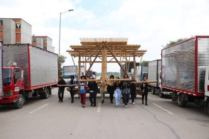 People carrying a bamboo structure