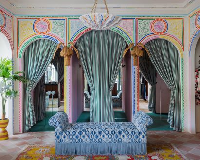 Blue patterned sofa and archways in London fashion store