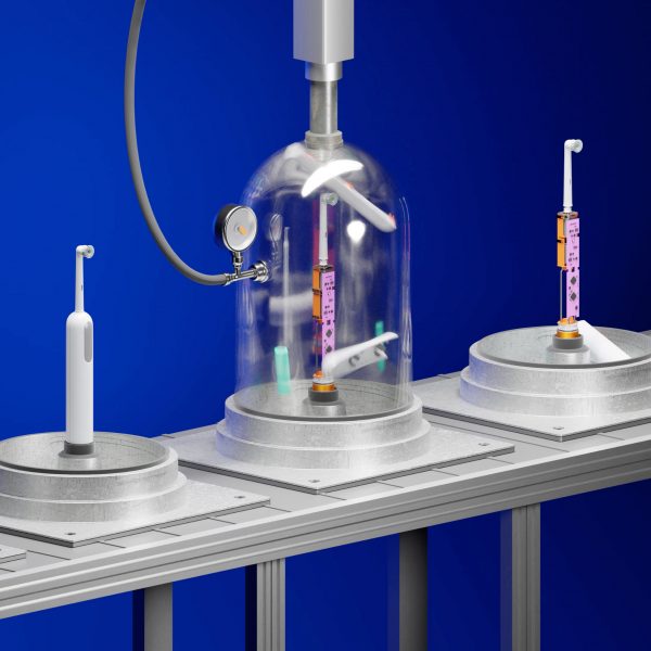 3D graphic of a series of electric toothbrushes on a conveyer belt. The one on the left is whole, the one in the middle is having its casing stripped from it under a clear dome, and the one on the right has its interior components exposed