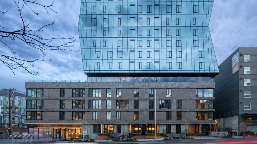 Glass facade skyscraper with stone podium