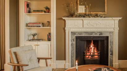 Lounge with fireplace inside Tigh Na Coille cottage by Wildland and Ruth Kramer