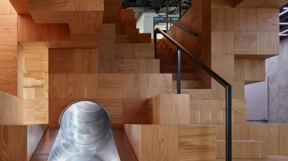 Collcoll hides stairs and seats in pixellated wooden structure at Pricefx office