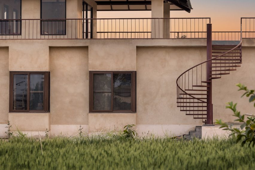 Exterior of Stone House by Sketch Design Studio with spiral staircase