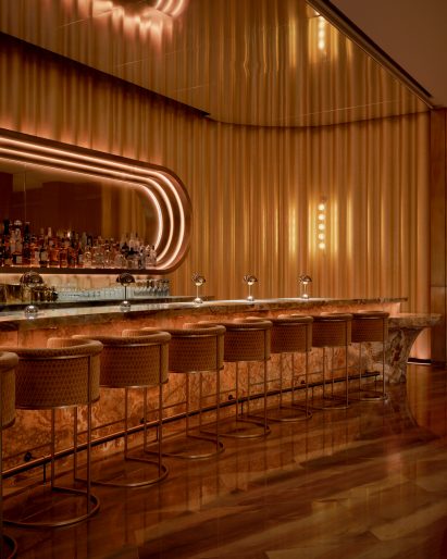 Bar at The Pinky Ring surrounded by golden drapes