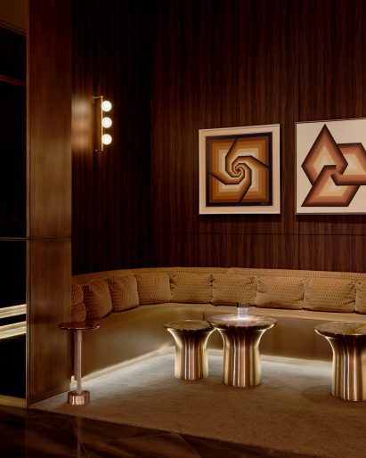 Seating area in a niche featuring dark wood-veneer panels
