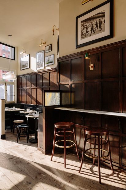 Entrance area of The Wren with walnut wall panelling and hardwood floors
