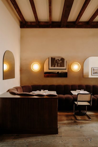 Chocolate-coloured velvet banquette featuring ribbed cushions