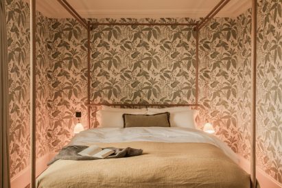 Bedroom with four-poster bed inside holiday home by Wildland and Ruth Kramer
