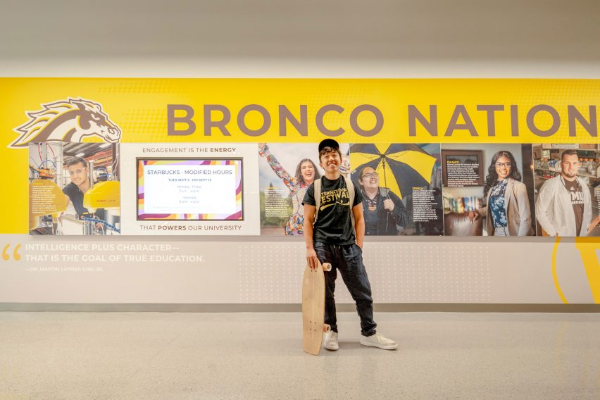 Kid in front of yellow sign