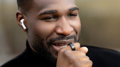 Photo of a man speaking into his WIZPR smart ring by VTouch
