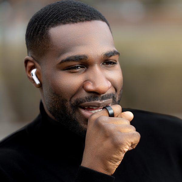 Photo of a man speaking into his WIZPR smart ring by VTouch