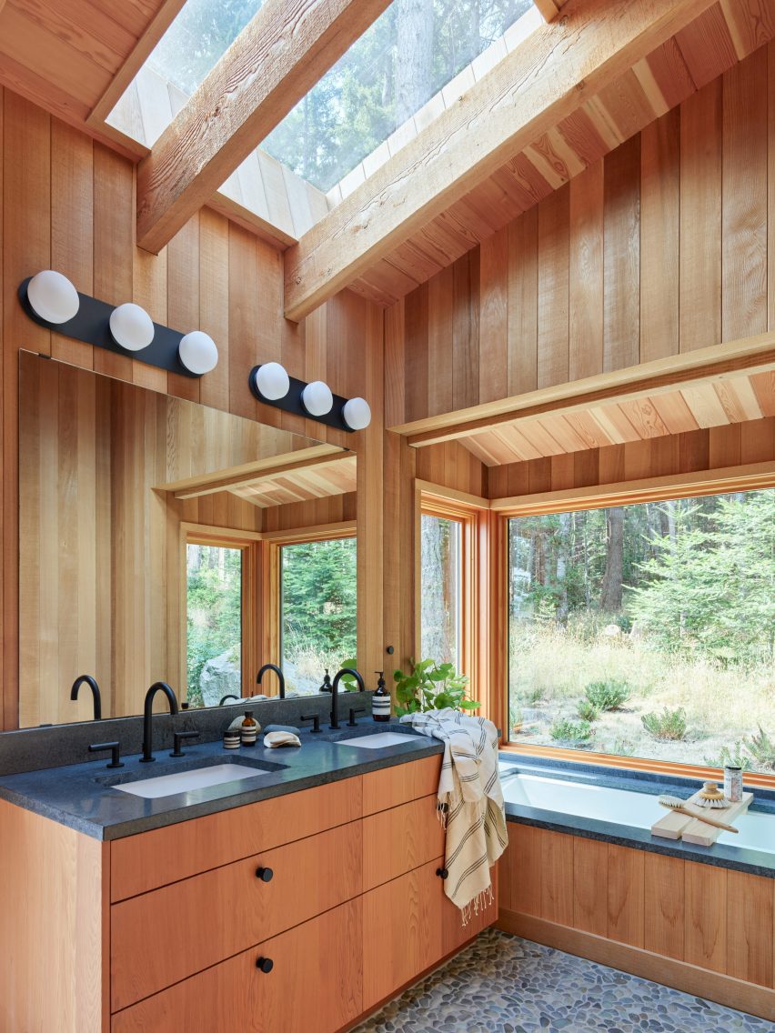A wooden cladded cabin with large windows