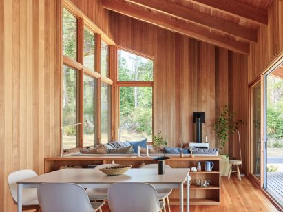 A seating area in a cabin with a wood burning fireplace