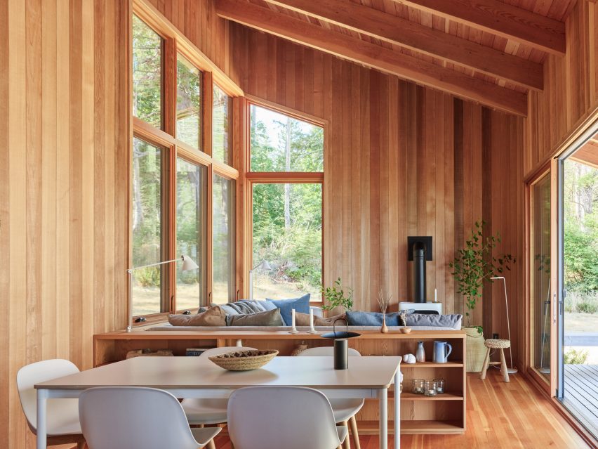 A seating area in a cabin with a wood burning fireplace