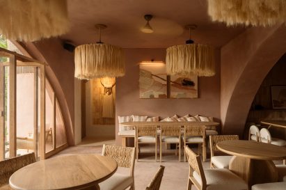 A dining room with pink walls