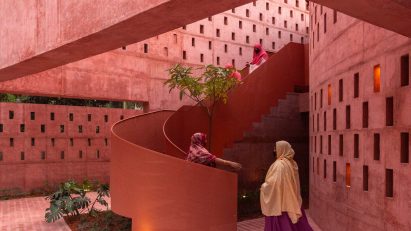 Women climbing up the spiral steel staircase of the Zebun Nessa Mosque by Studio Morphogenesis in Bangladesh
