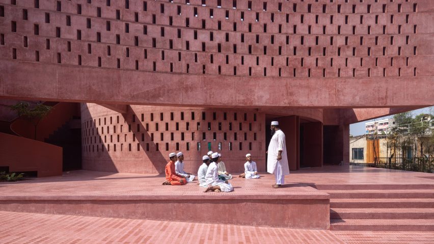 Worshippers sitting in front of the Zebun Nessa Mosque by Studio Morphogenesis in Bangladesh