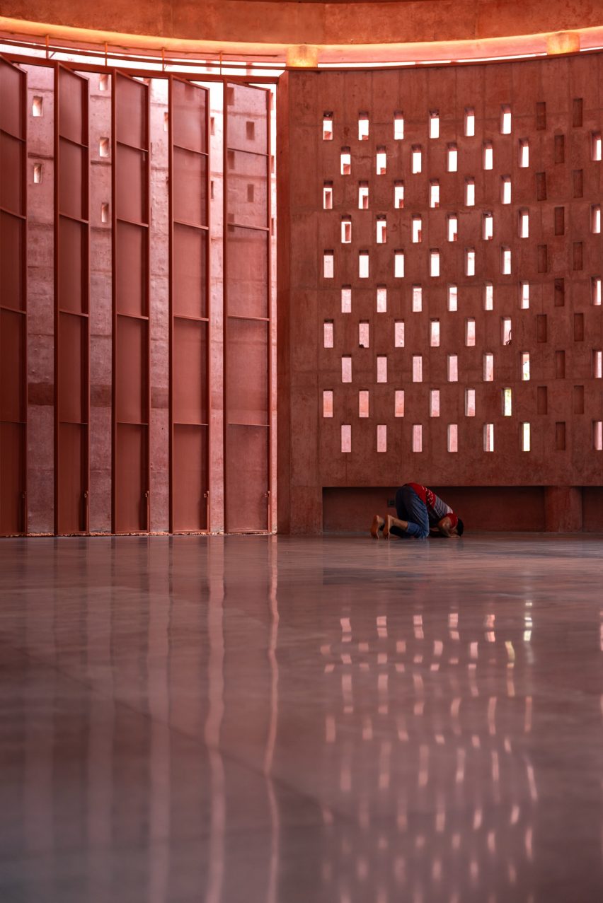 Worshipper praying in the Zebun Nessa Mosque by Studio Morphogenesis in Bangladesh