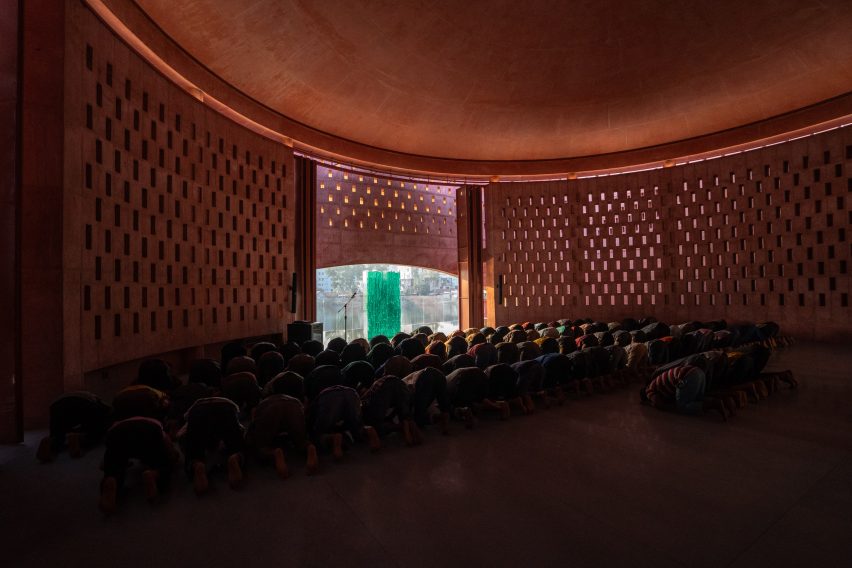 Worshippers praying in the Zebun Nessa Mosque by Studio Morphogenesis in Bangladesh