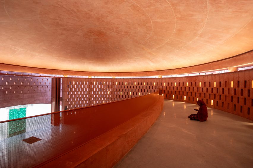 Female worshipper praying in the women's section of the Zebun Nessa Mosque by Studio Morphogenesis in Bangladesh