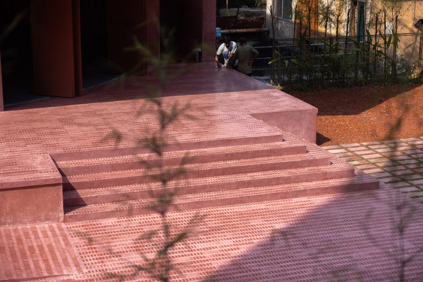 Red cement and broken brick mosaic floor of the Zebun Nessa Mosque by Studio Morphogenesis in Bangladesh