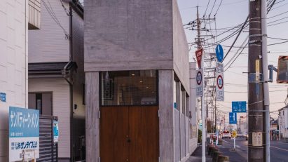 Skinny concrete house on roadside Japan