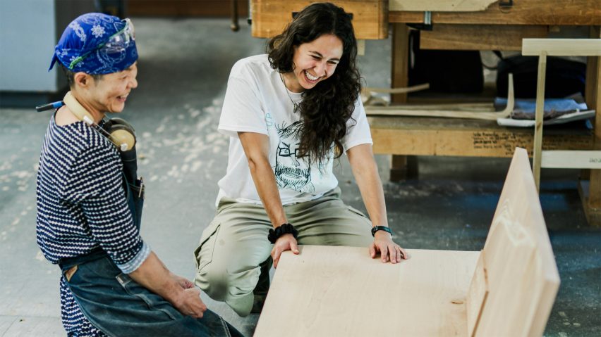 Photo of people looking at a wooden bench