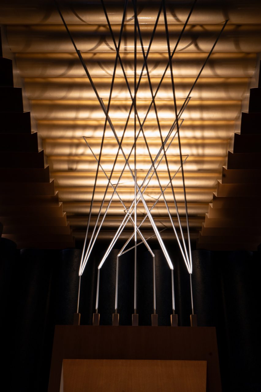 Metal rods that reach up from wooden chair