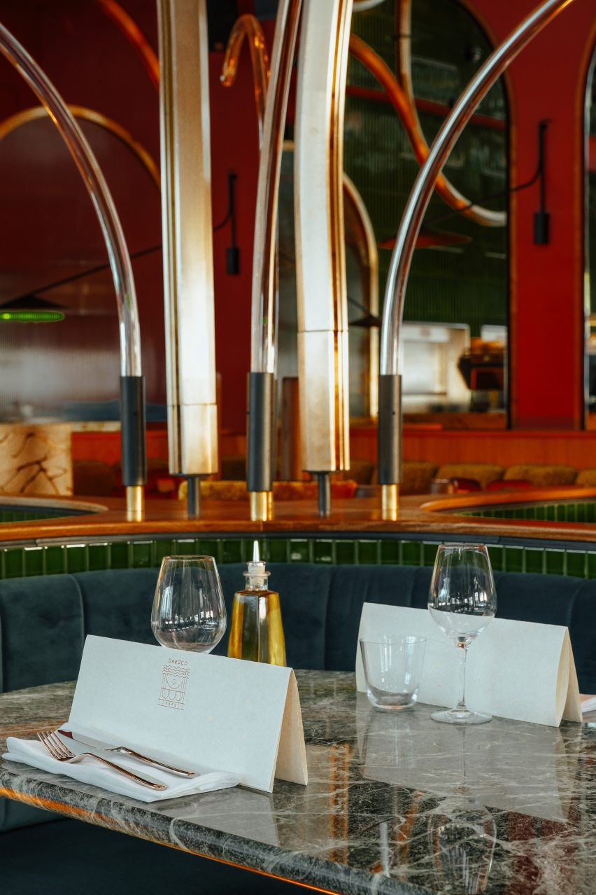 Green velvet dining seats at marble table