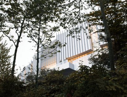 White building facade through the trees
