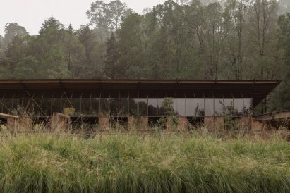 Stable building with large clerestory windows and sliding wood panels