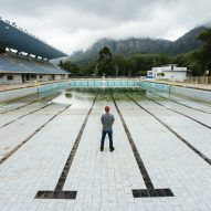 Photo of man standing in near-empty Newlands municipal swimming pool in Cape Town by Bloomberg via Getty Images
