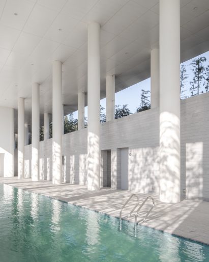 Swimming pool in white-walled room