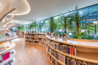 Wave bookshelves planted with fronds