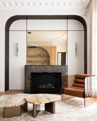 Living room with dark marble fireplace surround and contemporary furniture