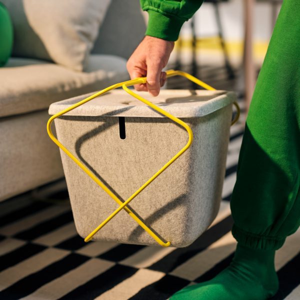 Hand holding felt basket from Brännboll gaming furniture collection by IKEA