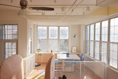 Dining area raised on a platform and surrounded by large windows