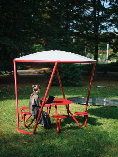 Woman sitting under UFO shelter by Mmcité
