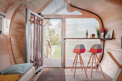 Living space within timber cabin by Peter Markos