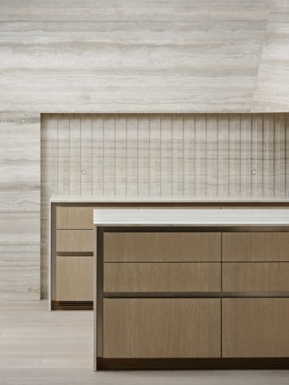 Kitchen with tone-on-tone travertine cabinetry and surfaces 