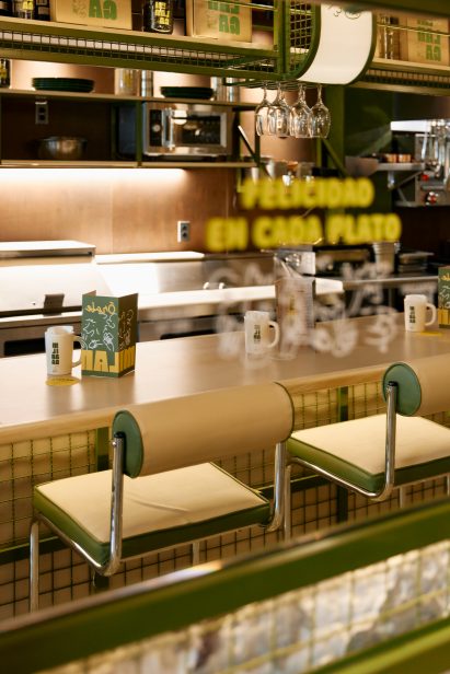 Tubular-steel stools accompany a pale wood bar counter