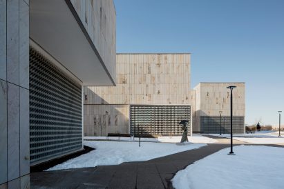 Snowy building view with sculpture