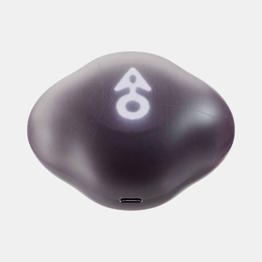 Product photo of the Terra device, showing a smoothened rock-like object with a glowing arrow pointing forward